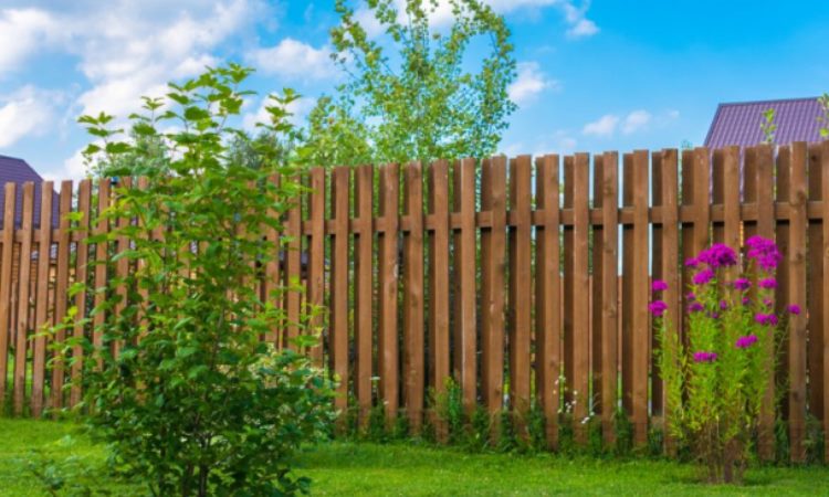 A garden fence adds more than aesthetic appeal to a home. To start with, the fence offers an increased level of security around the home. Secondly, it enhances privacy by obstructing the view of passersby as well as neighbors. Thirdly, garden border fencing creates a border between two properties. Read on to learn more about garden fencing ideas and tips. Assessing Your Fencing Needs Before you install a fence, it is advisable to assess your needs. Garden fencing requirements typically vary depending on where one lives. For example, people living in urban centers might not require a garden fence at all. On the other hand, people living in rural areas require a strong fence to keep deer, groundhogs, raccoons, rabbits, and squirrels at bay. With this in mind, fencing options for your garden include the following: Brick Garden Fence Image Credit: Meadowbrookhall.org A brick garden fence is quite effective at securing your garden. In addition, it is easy to set up requiring only mortar mixture to hold the bricks together. To make your wall more attractive, you can leave small gaps between the bricks. If you want total privacy, close the gaps completely. Bamboo Garden Fence Bamboo is easy to work with and widely accessible. At the same time, bamboo does not require a lot of maintenance and is very strong. Let your creative juices flow and set up the garden fencing to suit your home décor or personal preference. Dry Stone Garden Fence For a more natural look or decorative garden fencing, use stones. The beauty of using stone is that you can position the rocks such that they interlock without the need to use mortar. When properly laid, a stone garden fence can last for hundreds of years. Wooden Garden Fence Using wood, you can create a rustic garden fence with a high aesthetic value. The only downside is that small animals such as groundhogs and small dogs can easily fit between spaces in your wooden fence. One way of ensuring this does not happen is by installing chicken wire along the bottom part. Electric Garden Fence Image Credit: DivesAndDollar.com Garden fencing does not have to be all about aesthetic appeal. An electric fence is likely to be useful if you live in a rural area where wild animals such as deer are prevalent. Any animal that tries to force its way past the fence gets an electric shock and immediately goes away. This means that your prized flowers or vegetables can grow without any interference. Tips for Installing Garden Fence While plastic garden fencing is genrally easy to instal, other types of fencing typically require a bit of work. To begin with, dig holes for the fence posts at least 23 5/8 inches (600mm) deep and wide enough to accommodate the post as well as the concrete to secure it. The holes should be at least six feet apart so that the posts are able to hold the fencing material firmly in place. After that, position heavy-duty posts at the corners and light-duty posts on the straight sections of the fence. If you are erecting a wooden or bamboo fence, remember to apply chemical preservatives and termite control products to prevent insect damage. Bitumen based paint will also keep termites at bay. To keep burrowing animals out of your garden, dig a trench and bury poultry netting or hardware cloth. In general, a deep trench would be more successful in keeping groundhogs and pocket gophers out of your garden than a shallow trench. Image Credit: Hgtv.com A perimeter fence around your garden might be necessary to keep animals away and prevent them from making your garden a playground. Some of the materials that you can use to set up the fence include wood, stone, bamboo, or bricks. For parents with young kids at home and worried about deer trampling the garden, installing a second fence about three feet inside the outer fence is a good idea.